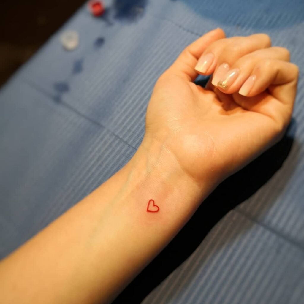 small red heart tattoo