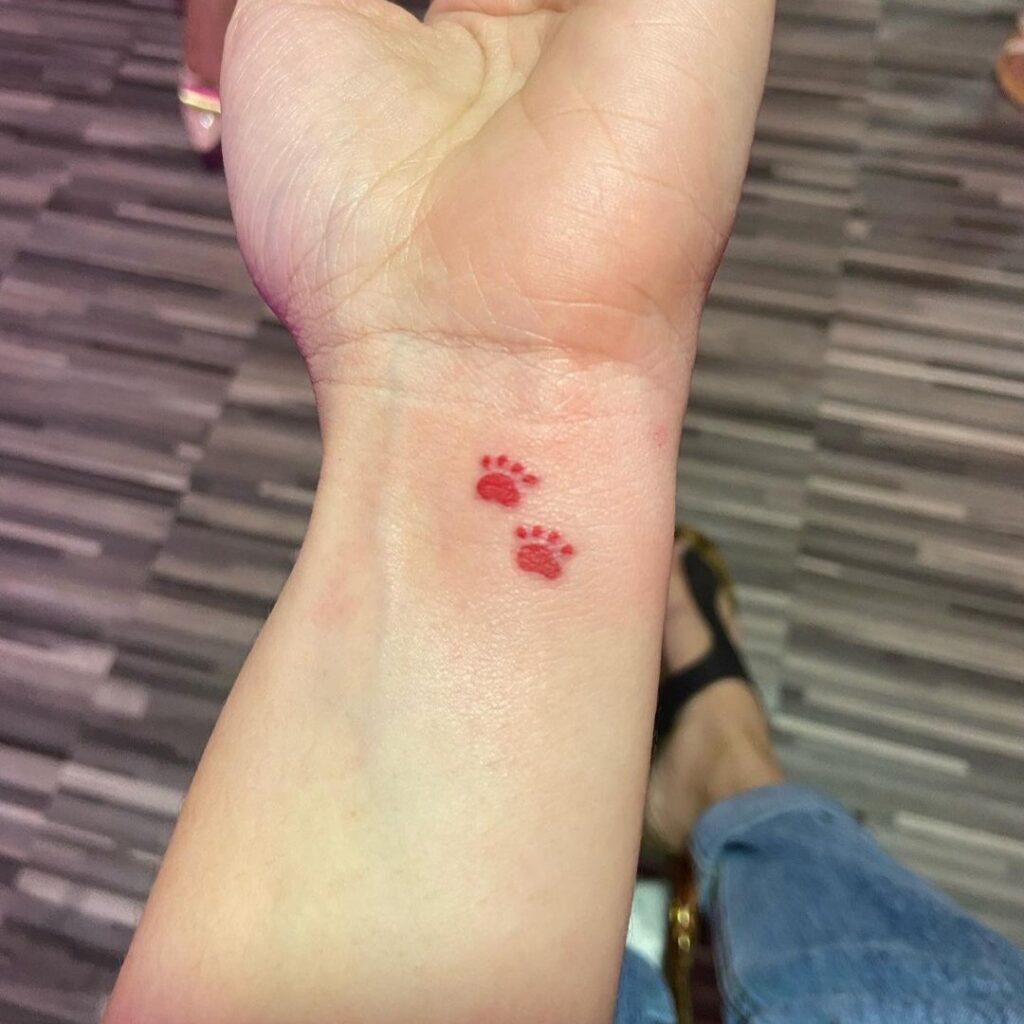 small red paw tattoo for women